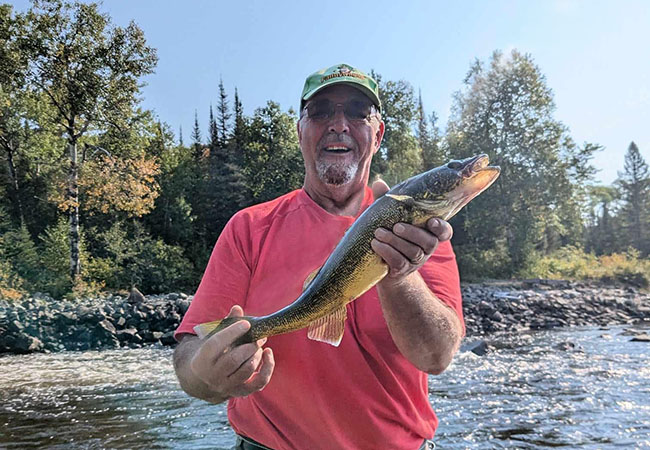 Biscotasing Sportsman Lodge Man In Red Shirt With Fish.jpg